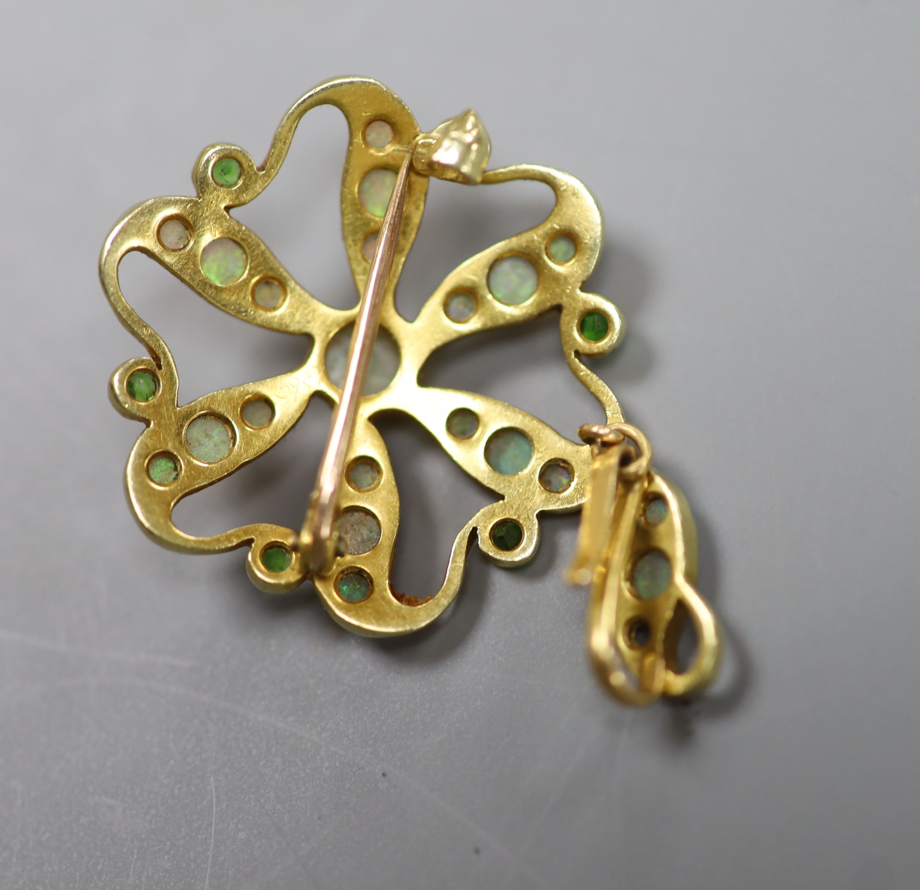 An Edwardian Art Nouveau yellow metal, opal and demantoid garnet cluster set pendant brooch